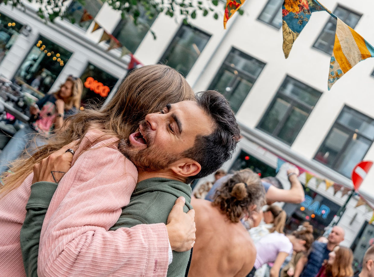 A hug in the middle of the street dance