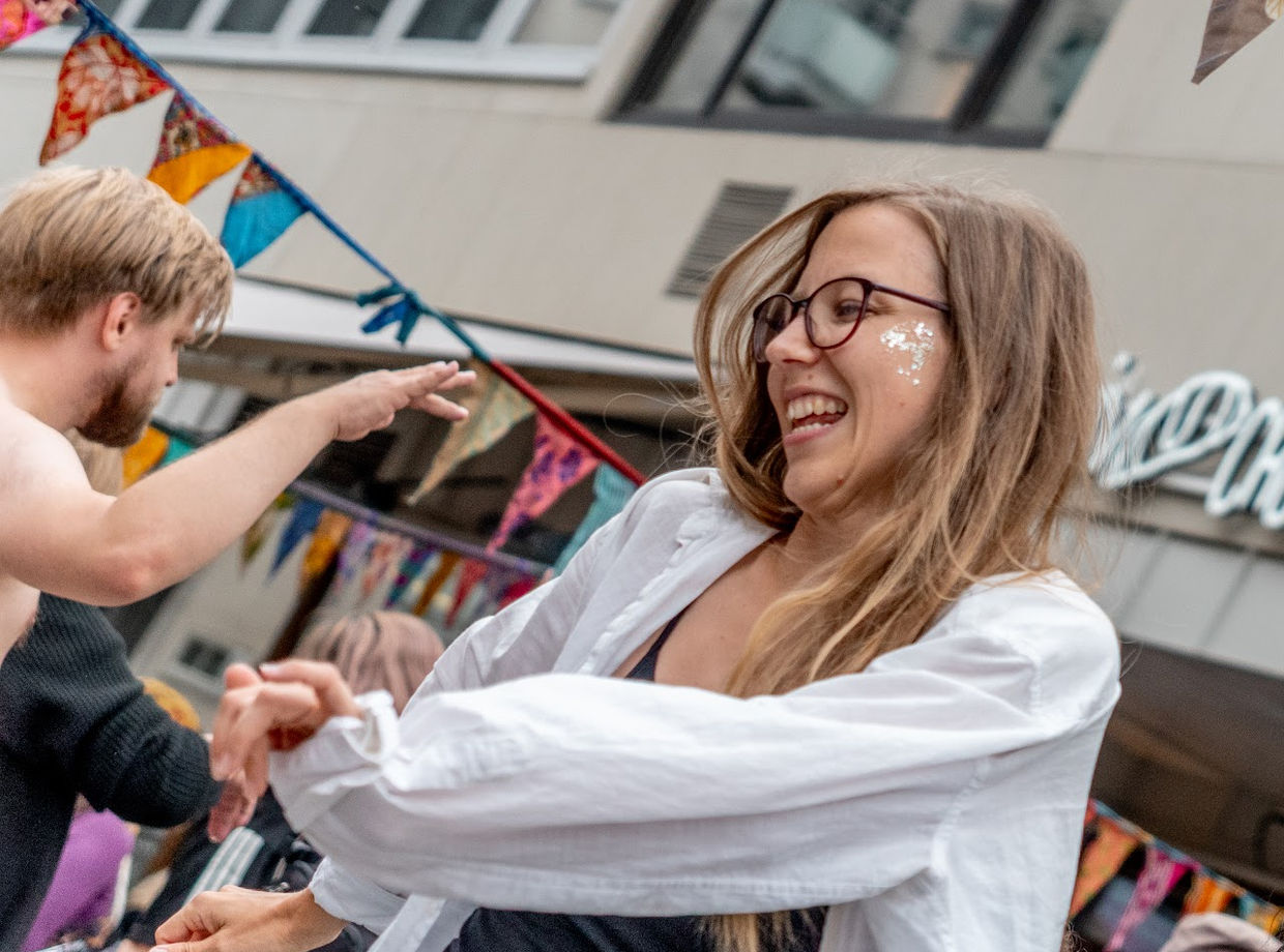 A dancer smiling mid-move