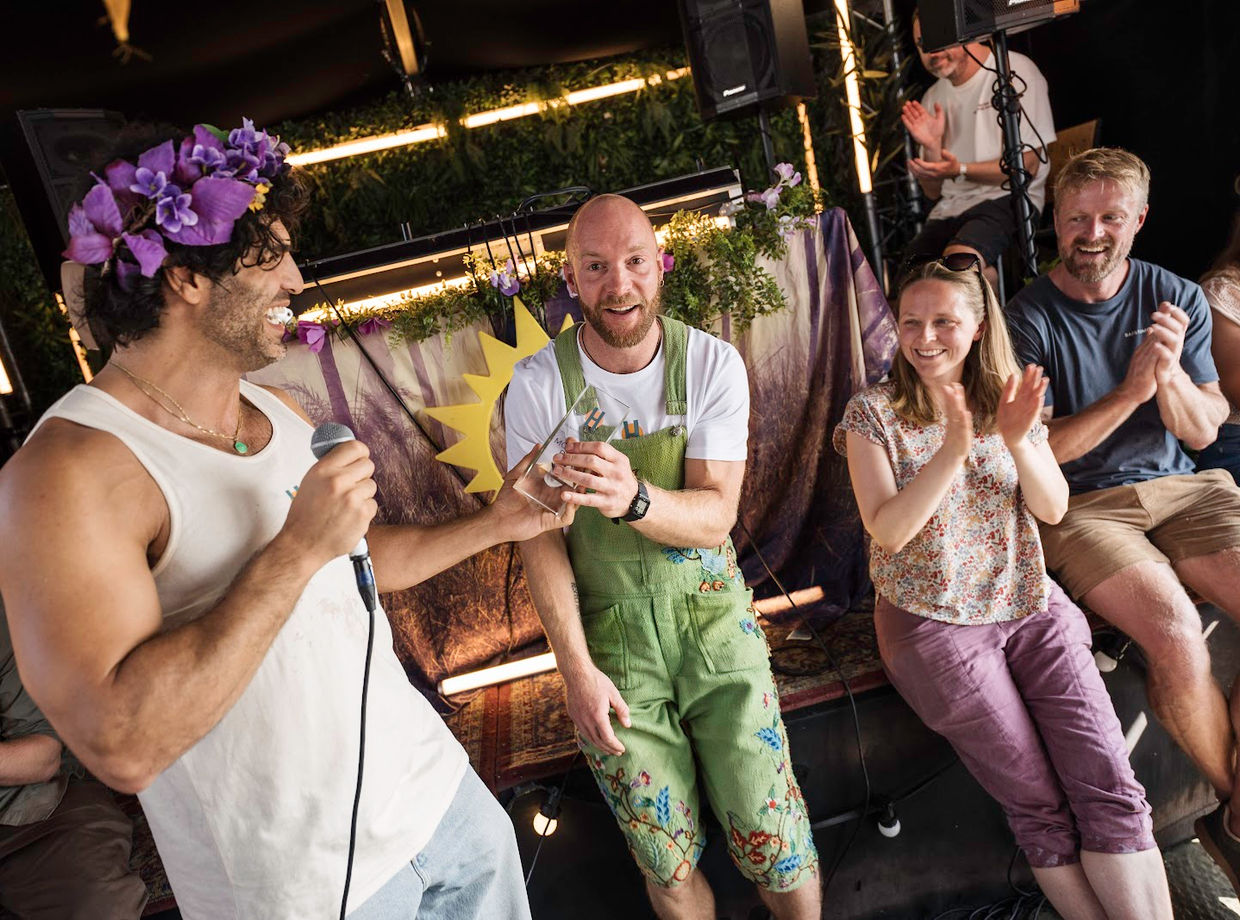 A singer with a flower crown on the mic