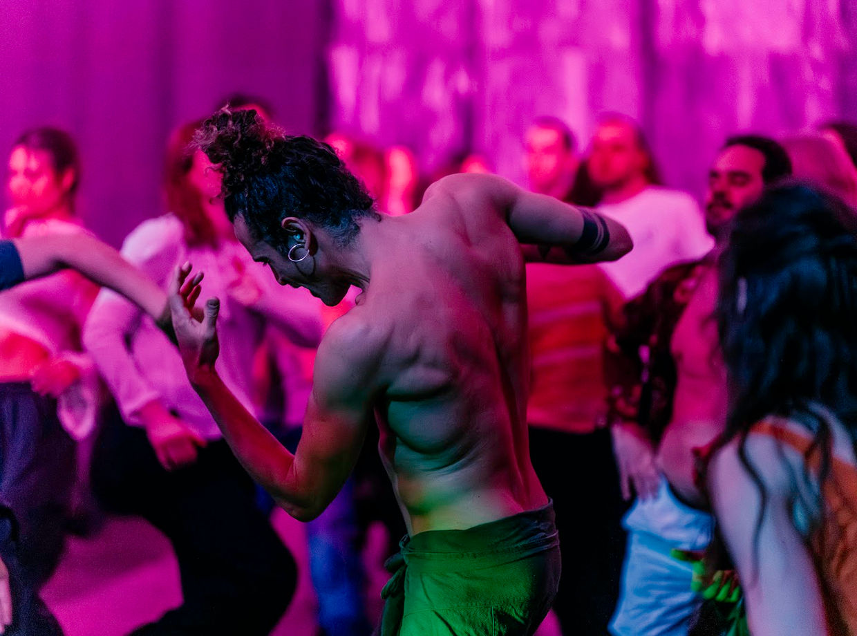 Dancers in bright pink light