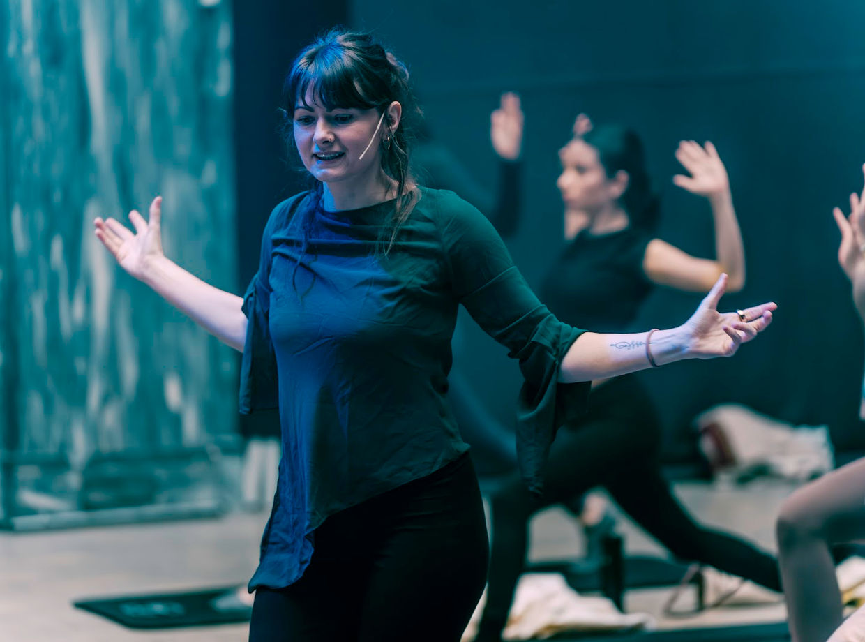 A dancer smiling mid-move