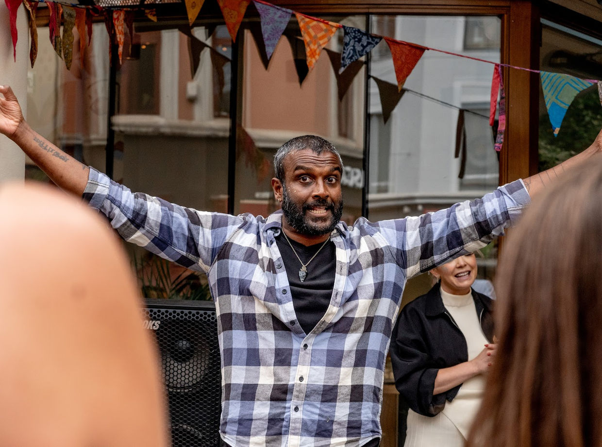 A dancer with his arms wide in the crowd