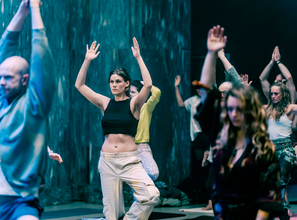 Dancers with hands raised to the ceiling