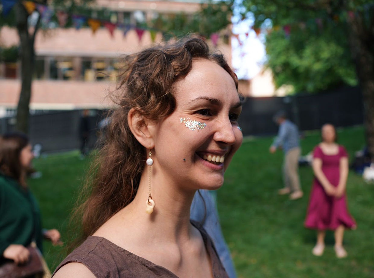A festival-goer smiling in the sunshine