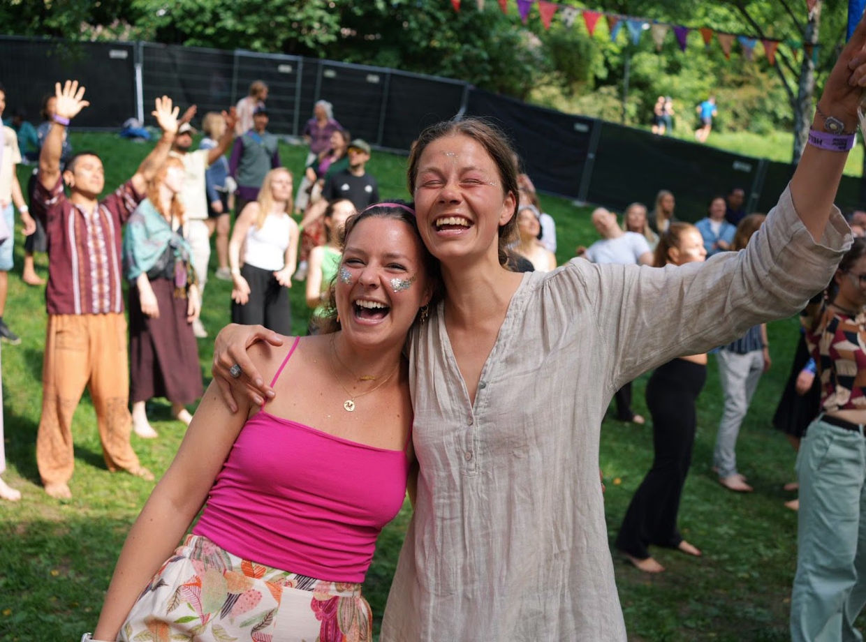 Two friends laughing together on the lawn