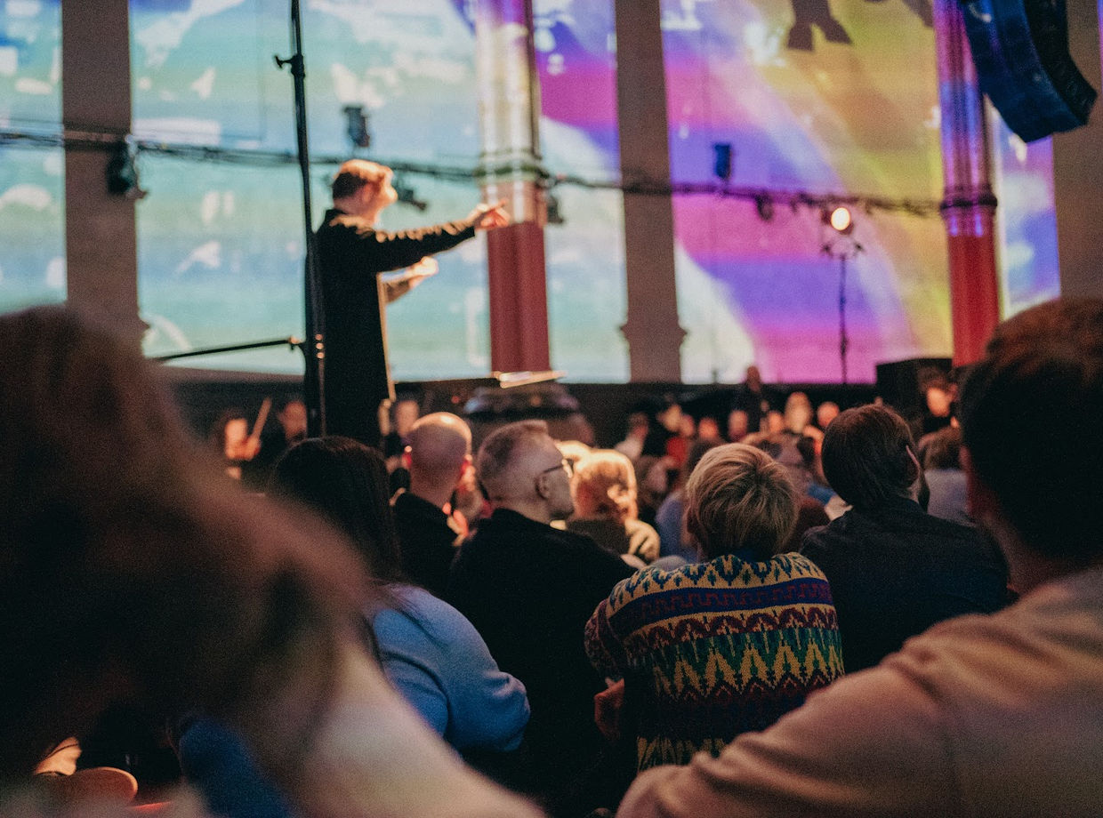 The audience under colourful projections