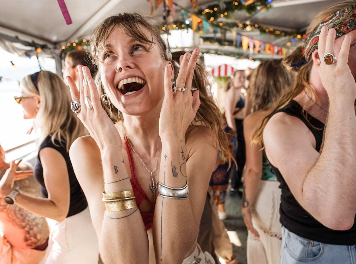 A dancer laughing with her hands up