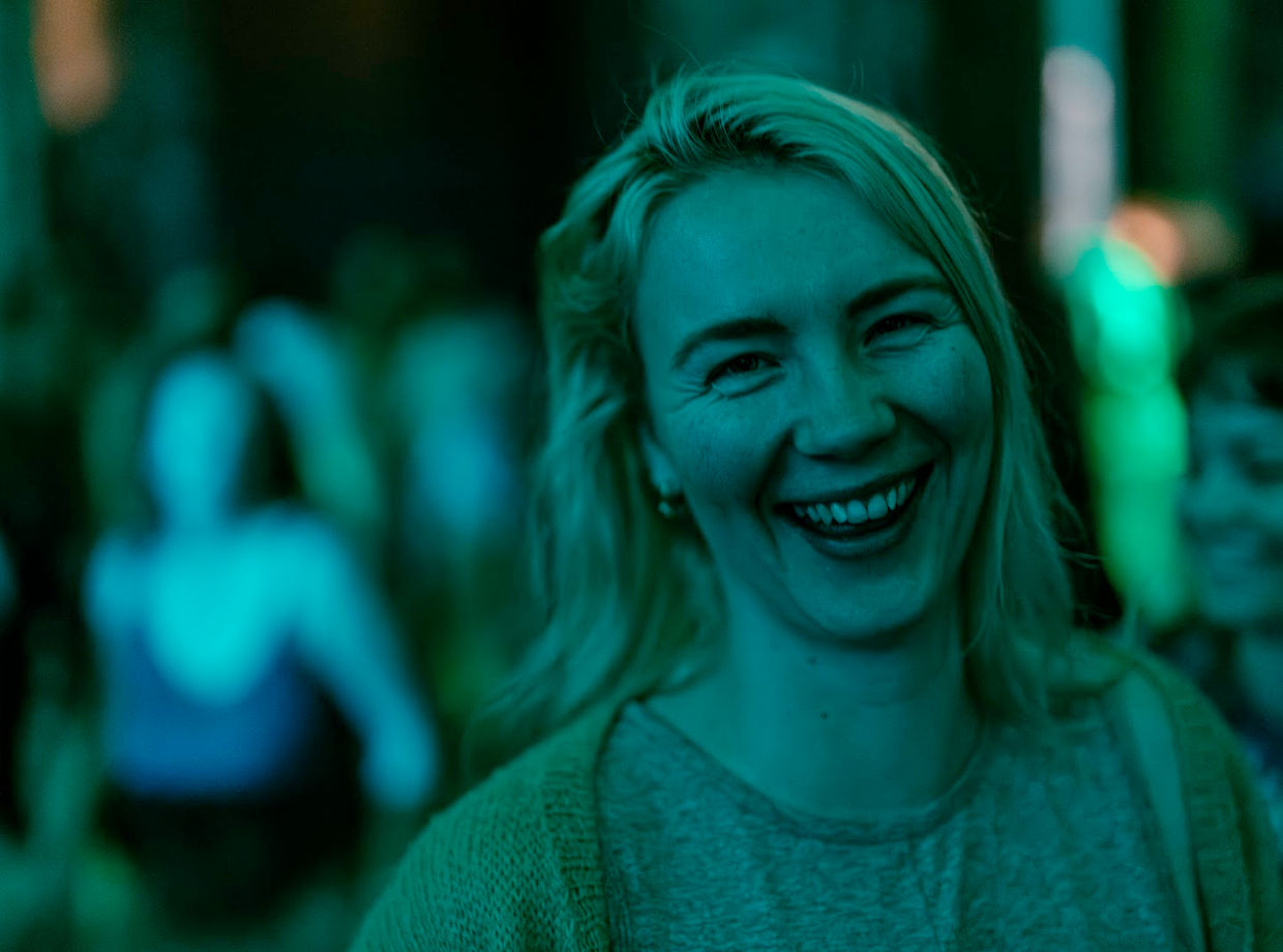 A dancer laughing in green light