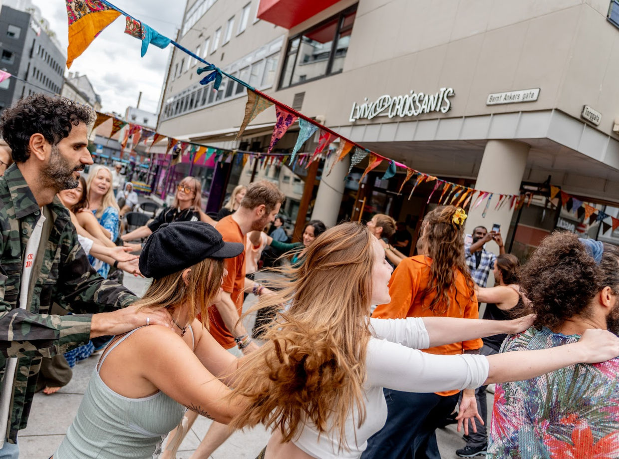 Dancers in a line under the bunting
