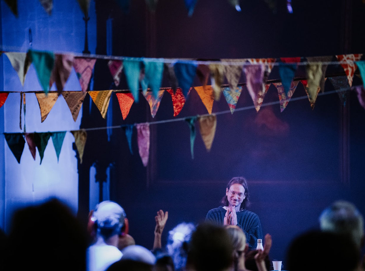 The crowd facing the stage in the church
