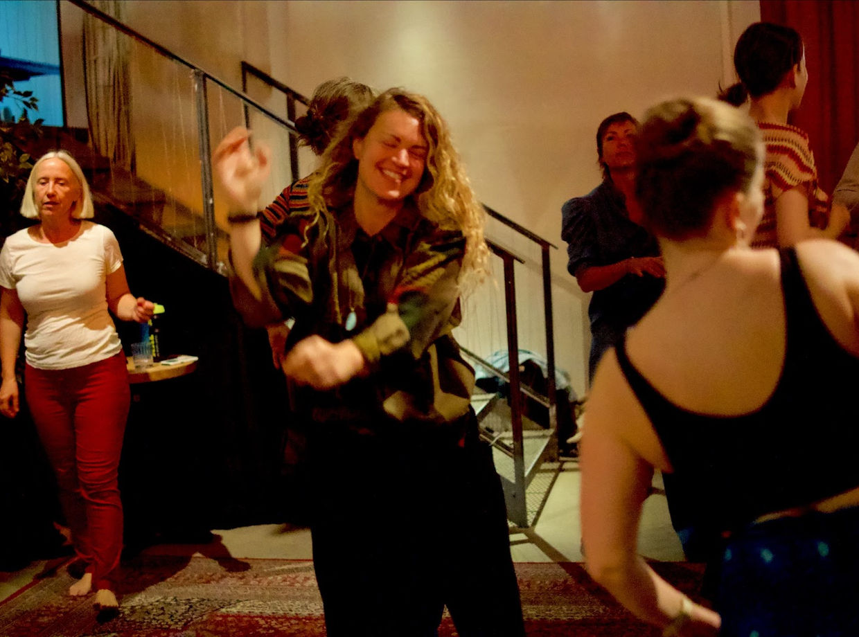 A dancer laughing on the dance floor