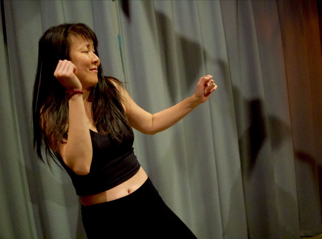 A dancer with eyes closed, smiling