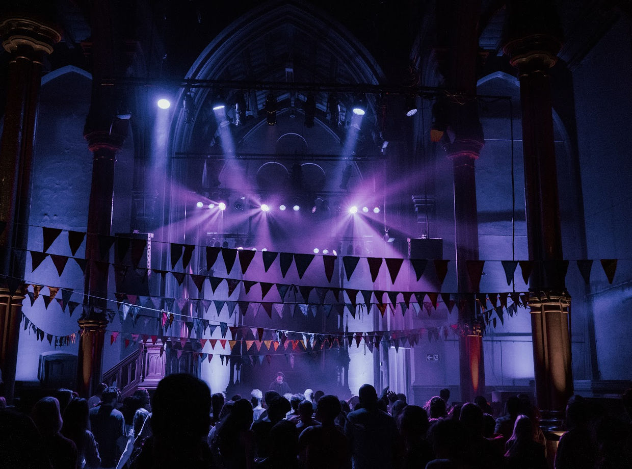 The church in stage light, packed with dancers
