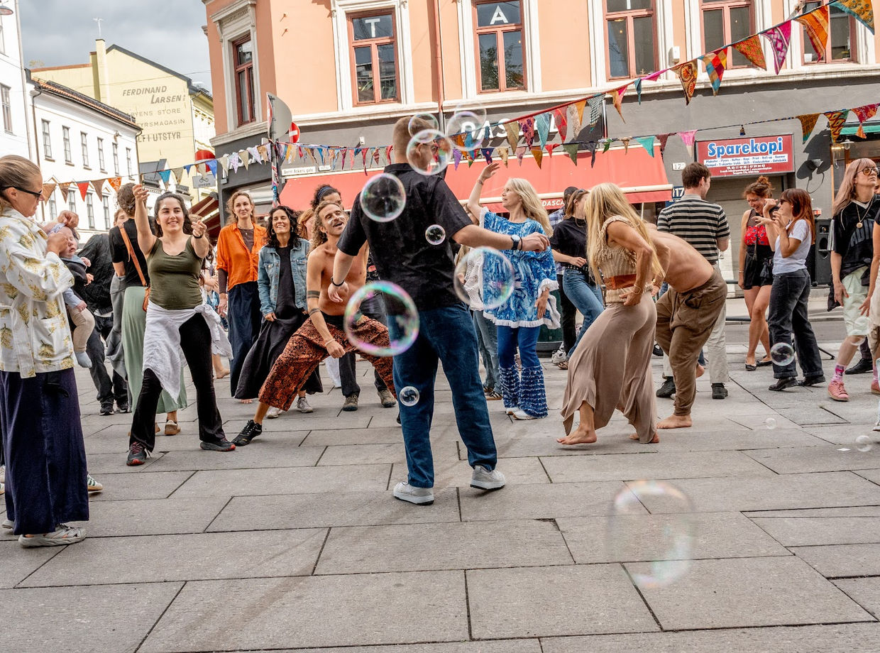 A crowd dancing down the street